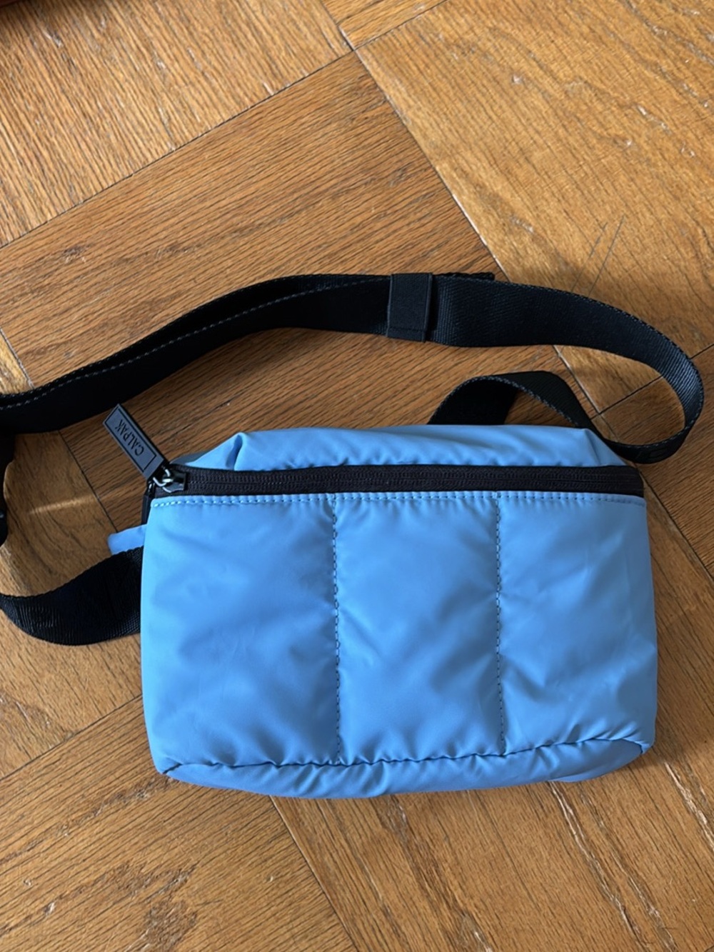 Calpak light blue padded mini crossbody bag with black strap